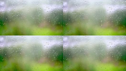 雨滴落在窗户玻璃上，背景是模糊的慢动作高清在线视频素材下载