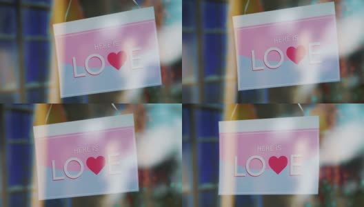 入口玻璃门上刻有“HERE IS LOVE”字样的标牌，4k慢镜头60fps高清在线视频素材下载