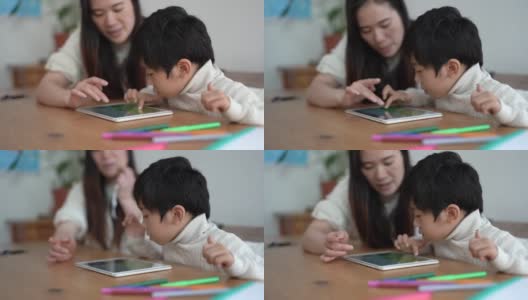 亚洲教师和孩子用平板电脑学习-妇女和儿童喜欢科技高清在线视频素材下载