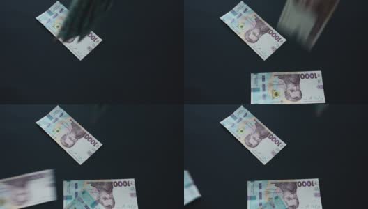 乌克兰的格里夫纳相当于1000格里夫纳，在黑色的背景上飞舞，这是乌克兰的国家货币，很多钞票高清在线视频素材下载