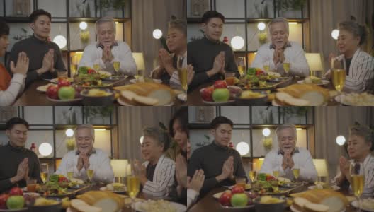 亚洲大家庭在家里吃饭前祷告祷告，祷告时闭上眼睛和双手高清在线视频素材下载
