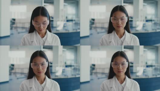 亚洲女性穿着实验服和眼镜在科学中心高清在线视频素材下载