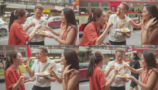 4K这群亚洲人朋友一起走在唐人街，一起吃街头小吃高清在线视频素材下载