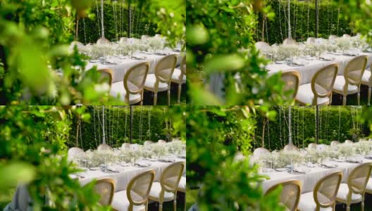 餐桌装饰在花园里，婚礼装饰在花园里蜡烛和装饰高清在线视频素材下载