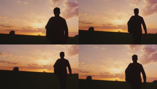 一个少年背着背包走向田野或乡村的夕阳。剪影视频，后视图。概念——新的研究，向未知的方向前进，离开家高清在线视频素材下载