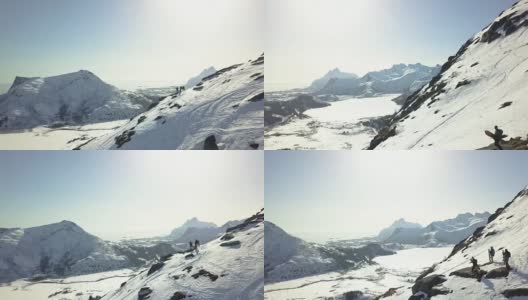 飞往挪威罗浮敦的滑雪板滑雪者站在山脊上。高清在线视频素材下载