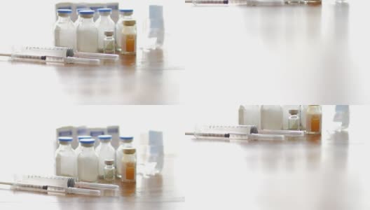 注射疫苗注射器与小瓶医疗近距离白色背景，小车拍摄倾斜高清在线视频素材下载
