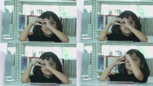 亚洲女孩在图书馆，心标志高清在线视频素材下载