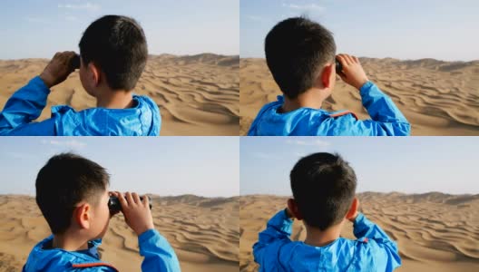 一个小男孩在沙漠里用望远镜看高清在线视频素材下载