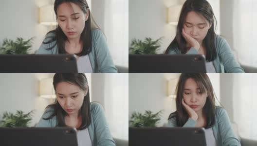 困倦的亚洲女商人坐在家里办公。她在办公桌旁玩笔记本电脑的时候睡着了。过度工作的女性自由职业者感到筋疲力尽的工作高清在线视频素材下载