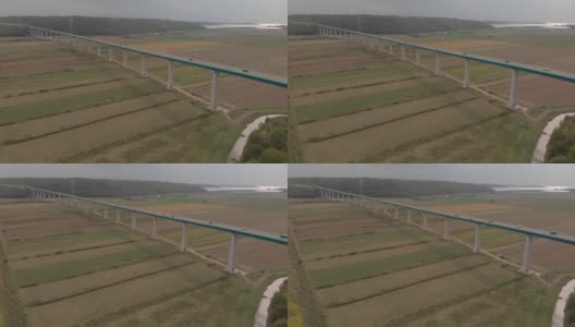 Flying over long Mirna bridge. Cars move on motorway over fields and river. Aerial of Croatia高清在线视频素材下载