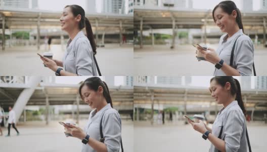 亚洲女商人在城市中行走时使用电话高清在线视频素材下载