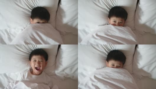 亚洲男孩在卧室里醒来玩躲猫猫高清在线视频素材下载