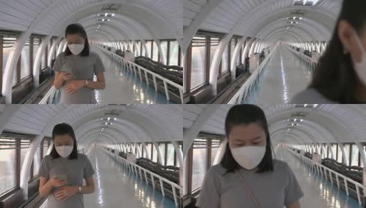 亚洲孕妇戴着口罩等待空中列车，新常态高清在线视频素材下载