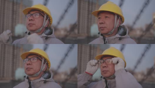 这位亚洲高级工程师用手拿着眼镜，晚上在电站工作高清在线视频素材下载