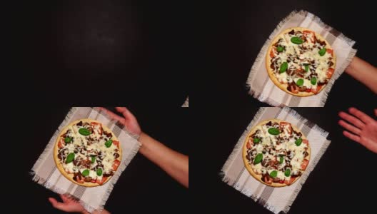 黑色混凝土背景上的披萨。马苏里拉奶酪、蘑菇、罗勒。为文本复制空间。从上面看，地势平坦高清在线视频素材下载