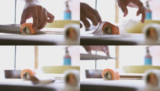 鱼块放在一卷米饭上炒。鲑鱼卷的准备高清在线视频素材下载