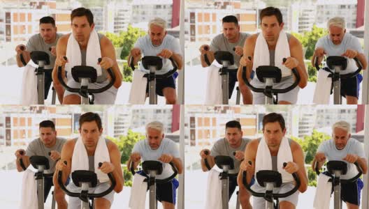三个男人在健身自行车上锻炼高清在线视频素材下载