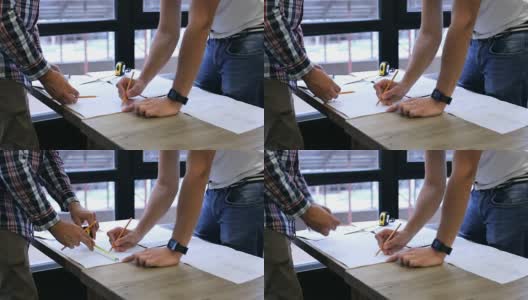 两名建筑工程师在办公室绘制图纸高清在线视频素材下载