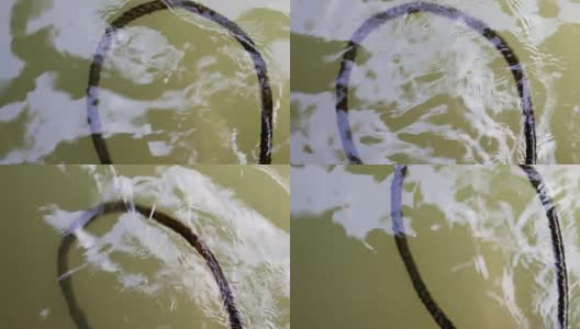 漂浮在水上的废弃旧绳子高清在线视频素材下载