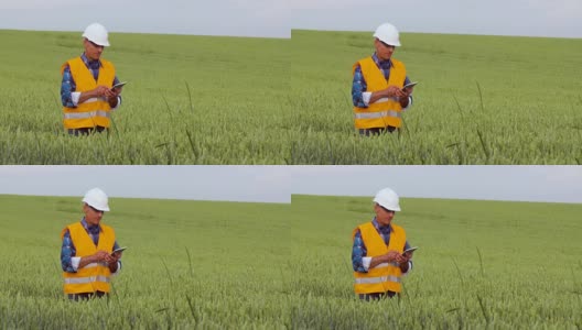 工程师在农场的作物中分析剪贴板上的检查表高清在线视频素材下载