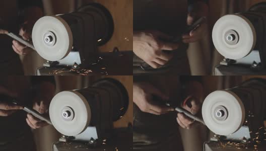 一名铁匠在磨刀盘上磨一个工件高清在线视频素材下载