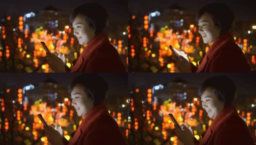 中国春节期间，一名女子用智能手机拍摄城市景观高清在线视频素材下载