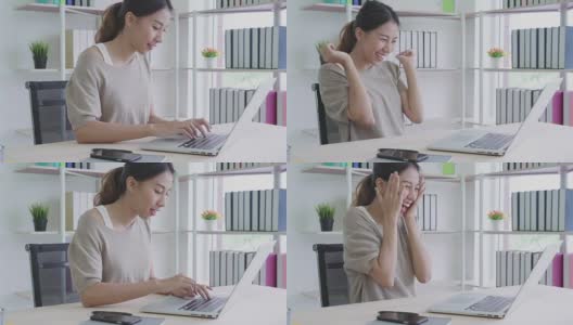 有吸引力的年轻亚洲女人在家里工作看着笔记本电脑兴奋，惊喜或感觉震惊的自由职业者潮概念的好消息。高清在线视频素材下载