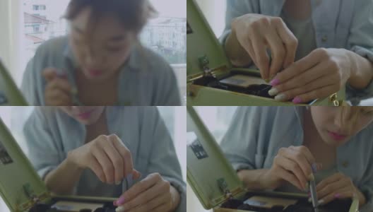 年轻的亚洲妇女正在修理一台老式收音机高清在线视频素材下载