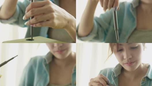 DIY:亚洲妇女用螺丝刀修理木钟高清在线视频素材下载