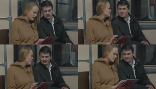 年轻人在移动的地铁列车上使用平板电脑高清在线视频素材下载