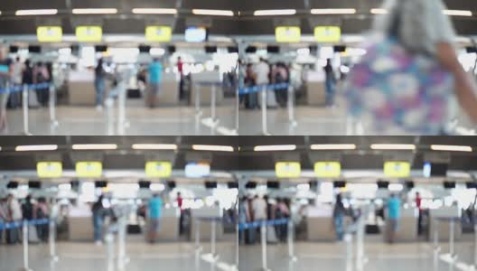 模糊画面显示，国际机场航站楼的乘客走向值机柜台。带有散焦效果的4K视频。高清在线视频素材下载
