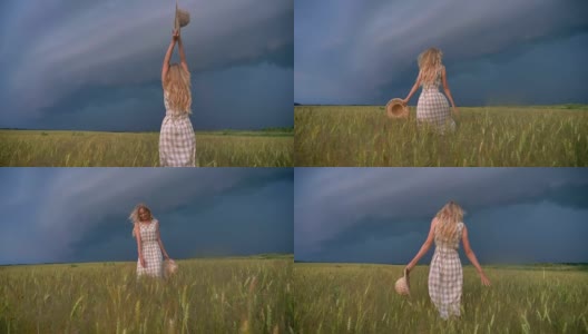 年轻美丽的灵感女孩是走在田野的雨天，自由的概念，底部的看法高清在线视频素材下载