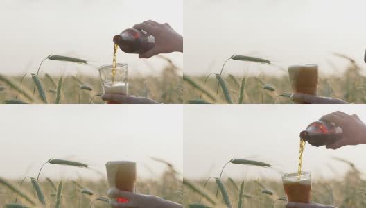 深色、带泡沫的啤酒从瓶中倒入玻璃杯，溅起，洒在玻璃杯上高清在线视频素材下载