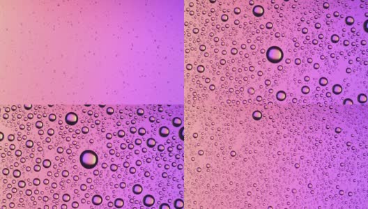 水珠出现在粉红色背景的玻璃表面高清在线视频素材下载