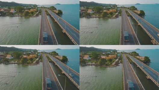 从鸟瞰图上看，卡车驾驶跨越泰国宋卡河上的桥梁高清在线视频素材下载