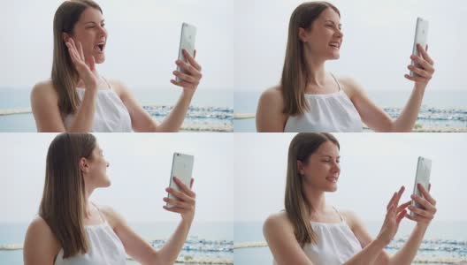度假的女人在阳台上通过手机messenger应用程序与朋友视频聊天的慢动作高清在线视频素材下载