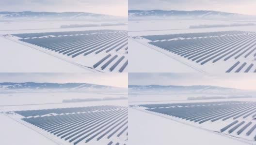 空中视角太阳能电池板农场绿色能源在冬季雪晴天高清在线视频素材下载