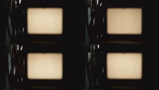 电影放映机在黑色背景上拍摄的视频高清在线视频素材下载