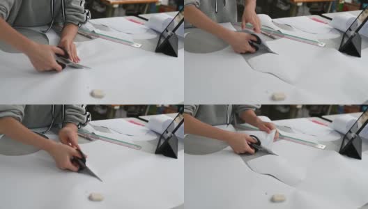 亚洲华裔女时装大学生在学院车间裁剪纸形缝制图案做服装项目高清在线视频素材下载