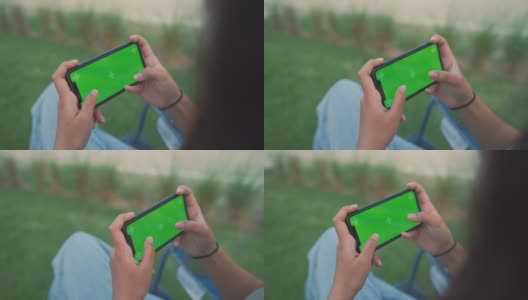 年轻女子使用手机绿屏高清在线视频素材下载