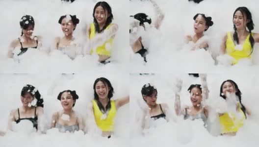 一群年轻女子在游泳池里玩泡沫和泡泡高清在线视频素材下载