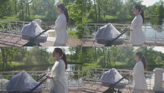 普希金的Tsarskoye Selo镇，妈妈推着婴儿车在春天的公园里散步。高清在线视频素材下载