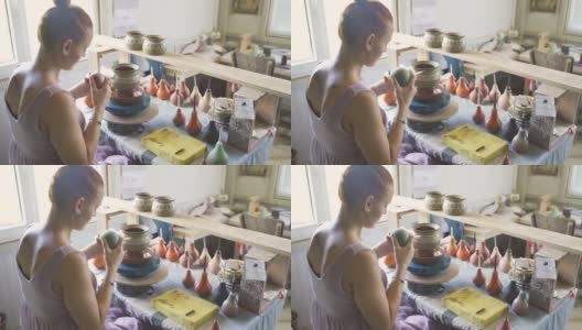 女陶工绘画和上釉陶罐精密使用特殊工具高清在线视频素材下载