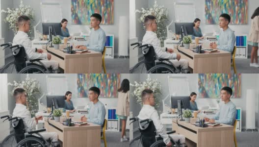 两个男人见面在公司的办公室面试上午残疾男孩到达轮椅穿着白衬衫老板坐在他的对面与他握手告别祝贺得到了工作高清在线视频素材下载