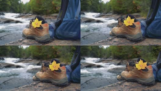 枫叶和加拿大国旗，河岸边徒步鞋，秋天加拿大徒步背景高清在线视频素材下载