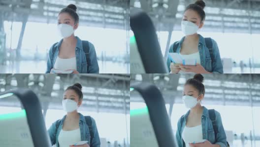 年轻的亚洲女性休闲布手出示护照和机票在工作人员的航空服务台办理旅行假期登记，安全旅行的亚洲女性带着口罩在机场候机楼办理登机手续高清在线视频素材下载