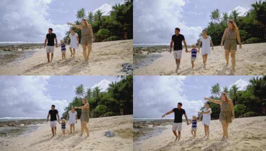 多代同堂的家庭沿着海滩散步高清在线视频素材下载