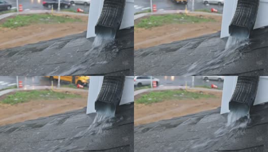 强烈的雨水落在前景的一个屋顶上，从排水沟流高清在线视频素材下载