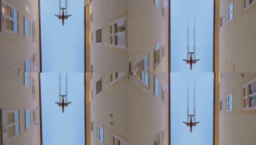 在城市里，飞机顶着蓝天在建筑物之间飞行高清在线视频素材下载